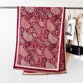 Close-up of red paisley pattern pashmina shawl with tassel detail and fashion card - Classic Paisley Red