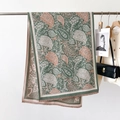 Close-up of green paisley cashmere scarf with delicate fringe on a premium hanger - Classic Paisley Aqua Green