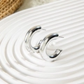 Macro detail of silver geometric C-shaped hoop earrings with polished mirror finish - Versatile Minimalist C-Shape Mirror Earrings (28578-10-silver)