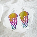 Dettaglio di orecchini a forma di medusa arcobaleno su uno sfondo di pietra bianca - Medusa Gradiente Giallo-Viola (29227-2)