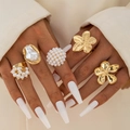 Detail of five-piece gold metal ring set with baroque pearls and floral designs - 5-Piece Gold Flower Cluster Artificial Pearl Set (29485-G)