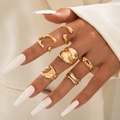 Detail of 7pcs irregular geometric gold rings set worn on hand for a vintage aesthetic - Gold Irregular Fluid Set (29417-G)