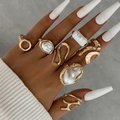 Detailed close-up of 7-piece gold geometric ring set with baroque pearl accents on hand - Gold Wave Irregular 7-Piece Set (30624-ring-G)
