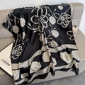Elegant black silk scarf with white camellia floral print on a luxury grey sofa - 80x178cm / Black Camellia Style (F-427)