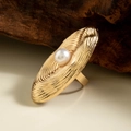 Macro detail of golden oval ripple ring with central pearl on a rustic wooden stand - Gold - Ripple Texture Pearl Style (29458-5-G)