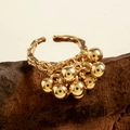 Detail of adjustable gold spiral ring with hammered texture and hanging metallic beads - Gold - Round Bead Pendant Style (29458-7-G)