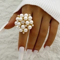 Close-up of golden cluster ring with white pearls and sparkling crystals on finger - Gold - Pearl Rhinestone Flower Cluster Style (30695-ring-G)