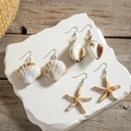 Three pairs of beach-style shell, conch, and starfish earrings on silver hooks - White Conch And Starfish And Shell Styles (29374-white)