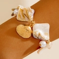 Ocean style bracelet featuring natural shell, golden scallop charm and white pearls - White Shell Style (29305-bra-white)