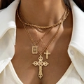 Close-up of gold multilayer necklace featuring ornate cross pendants and zircon accents - American Vintage Triple Pendant Layered (30683-nek-G)