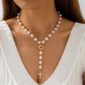 Detailed close-up of a Y-shaped gold cross necklace with pearls and heart clasp on neck - Heart Connector Pearl Cross (30713-nek-G-1)