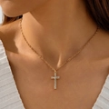 Close-up of a gold cross pendant with sparkling zircons worn by a model on a white shirt - Minimalist Rhinestone Cross Fine Chain (30739-nek-G-1)