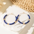 French style hoop earrings with deep blue beads and gold spacers on a white stone - Blue