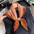 Detailed close-up of paisley pattern silk scarf tied on a vest with vintage aesthetic - Square / Orange Paisley