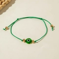 Detail of green woven Evil Eye bracelet with golden beads and adjustable bohemian cord - Green Braided Rope (30532-bra-green-2-EP)