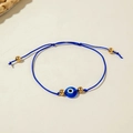 Close-up of blue woven Evil Eye bracelet with gold beads and adjustable cord - Dark Blue Braided Rope (30532-bra-D Blu-3-EP)