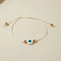 Detailed close-up of a white braided Evil Eye bracelet with gold beads and pull-string adjustment - White Braided Rope (30532-bra-white-4-EP)