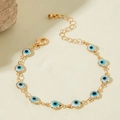 Detail showing gold chain bracelet with blue evil eye charms and a secure lobster clasp - White Beaded Chain (30720-bra-whi-5-EP)
