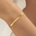 Detailed view of a flat gold-plated herringbone chain bracelet on a wrist - Gold Flat Snake Bone Bracelet (30633-bra-G)