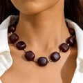 Detail of dark brown acrylic square beads chunky necklace on model wearing white shirt - Brown Square Style