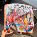 Silk square scarf with giraffe and castle print shown on a textured tabletop - 53*53cm / Orange Edge - Giraffe Architecture Print