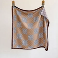 Plaid square silk scarf with brown checkerboard and blue swirl patterns hanging on a clip - 70cmx70cm / Khaki