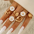 Set di 7 anelli dorati a tema oceanico con stelle marine e conchiglie per donna - Stile Marino Dorato (30881-ring-G)