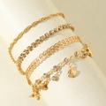Set of four gold-plated bracelets featuring crystal claw chains and shell charms on a display - Gold Shell Rhinestone Set (31105-ank-G-EP)