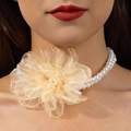Macro detail of double-layer pearl choker featuring a large champagne organza flower petal - Champagne