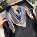 Classic paisley pattern silk scarf in blue and grey draped on a wooden hanger - 70*70cm / Blue