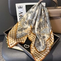 Elegant silk scarf with paisley and floral prints styled on a handbag and chair - ZC-275-Light Yellow