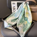 Green silk lotus print scarf draped on a tray with heart-shaped crystal brooch accessory - 100% Mulberry Silk / 65x65cm / Beige and Green