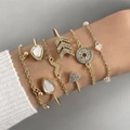 Detail of layered gold geometric bracelets featuring stars and rhinestones on a wrist - Lightning Star And Moon Six Piece Gold Bracelet Set (25863-1-G)