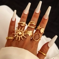 8-piece bohemian gold ring set with sun, starfish, and shell motifs on hand - Gold Sun Starfish 8-Piece Set (30406-ring-G)