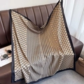 Detail of classic houndstooth and chain pattern silk scarf displayed on a leather sofa - Chain Houndstooth Khaki (XW-169-Khaki)