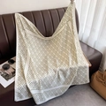Detail of a large silk square scarf featuring olive green geometric patterns on ivory silk - Green