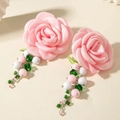 Detail of pink satin flower earrings with colorful beaded tassels and green leaf accents - Pink