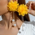 Close-up of yellow fabric flower earrings with gold chain tassels and white pearls - Yellow
