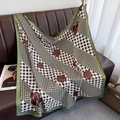 Plaid and camellia print silk square scarf elegantly draped on a brown leather sofa - 90*90cm / Green Edge (XW-173)