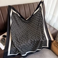Close-up of black and white geometric pattern scarf draped on a leather background - 90*90cm / Black (XW-181)