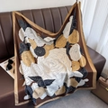 Detail of elegant satin square scarf with vintage floral patterns on a leather sofa - 90x90cm / Coffee