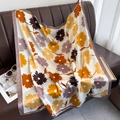 Detailed view of vintage floral silk scarf with lilac border draped on a brown leather sofa - 90*90cm / Yellow