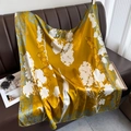 Mustard yellow silk scarf with white floral print draped on a leather sofa - L / Ginger Yellow