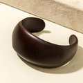 Macro detail of a minimalist wide open acrylic bangle in deep coffee brown finish - Minimalist Wide Style (31197) / Dark Brown