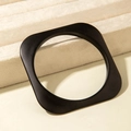 Close-up of minimalist black geometric acrylic bracelet with a matte finish on a stand - Rounded Square Style (31199) / Matte Black