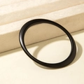 Close-up of minimalist black matte acrylic bracelet with unique geometric tapered design - Asymmetrical Art Style (31201) / Matte Black