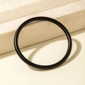 Detailed view of black round acrylic bangle with a smooth matte frosted finish texture - Minimalist Ring Style (31203) / Matte Black
