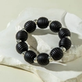 Close-up of matte black threaded beads and polished silver beads on a stone surface - Black Silver Threaded Round Style (31224-bra-black-EP)