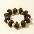 Detailed close-up of acrylic beads and gold-tone spacers on an elastic bracelet - Pitted Texture Gold Brown Style (31231-bra-G-EP)