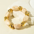 Detailed close-up of ethnic style beaded bracelet with marble texture and gold spacers - Off-White Irregular Bead Bracelet (31604)